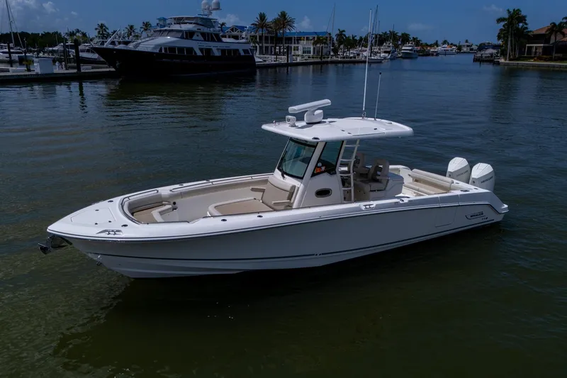 Slide: The Image of 2020 Boston Whaler 330 Outrage boat docked in a marina. - 8