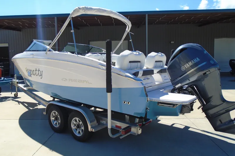 Slide: The Image of 2020 Regal LX4 boat with Yamaha outboard motor on trailer. - 1