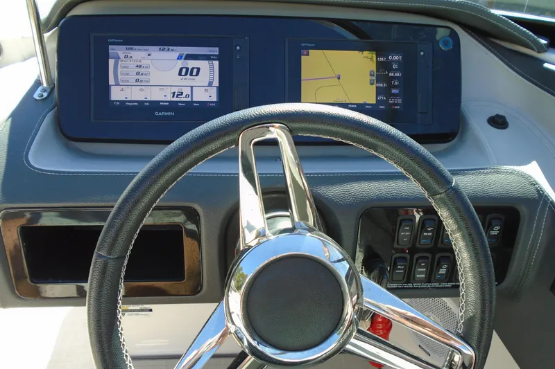 Slide: The Image of Steering wheel and dashboard of 2020 Regal LX4 boat with Garmin displays. - 17