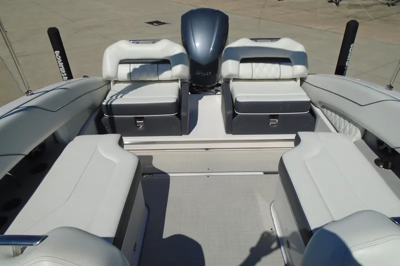 Slide: The Image of 2020 Regal LX4 boat interior with white seating and powerful engine. - 20