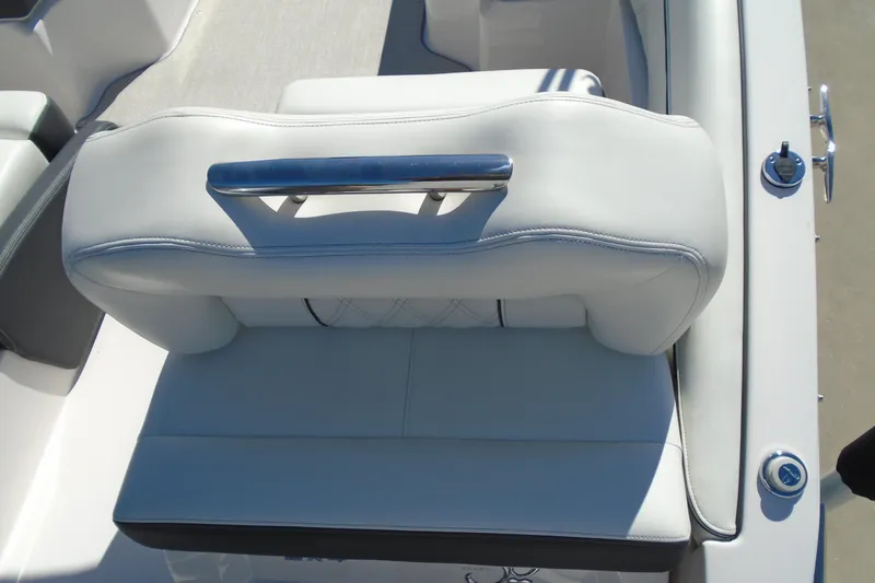Slide: The Image of 2020 Regal LX4 boat seat with white upholstery and chrome handle. - 21
