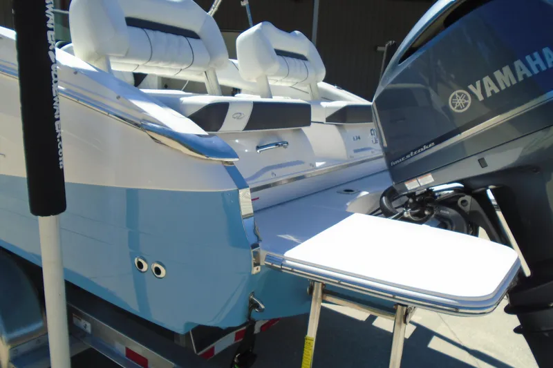 Slide: The Image of 2020 Regal LX4 boat with Yamaha outboard motor, featuring a sleek blue and white design. - 23