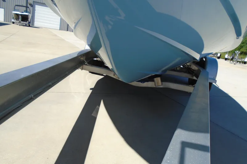 Slide: The Image of 2020 Regal LX4 boat on trailer, viewed from below, in a sunny outdoor setting. - 26