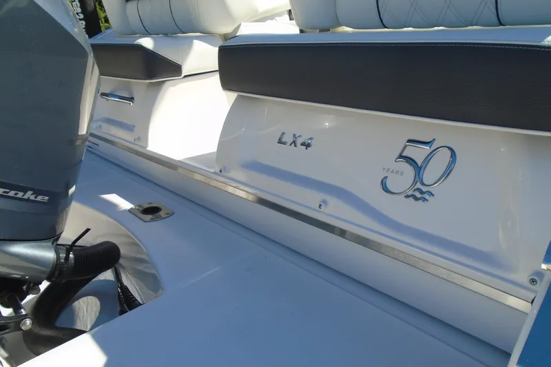 Slide: The Image of 2020 Regal LX4 boat interior with 50th anniversary emblem, featuring sleek seating design. - 9