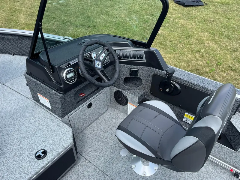 Slide: The Image of 2026 Lund 1875 Impact XS Sport boat interior with seating and console. - 11