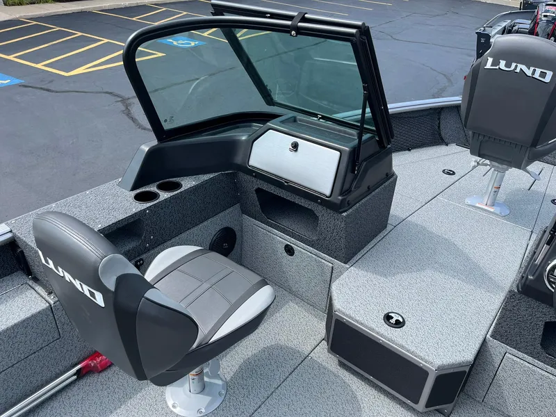 Slide: The Image of 2026 Lund 1875 Impact XS Sport boat interior with open storage compartments and seating. - 16