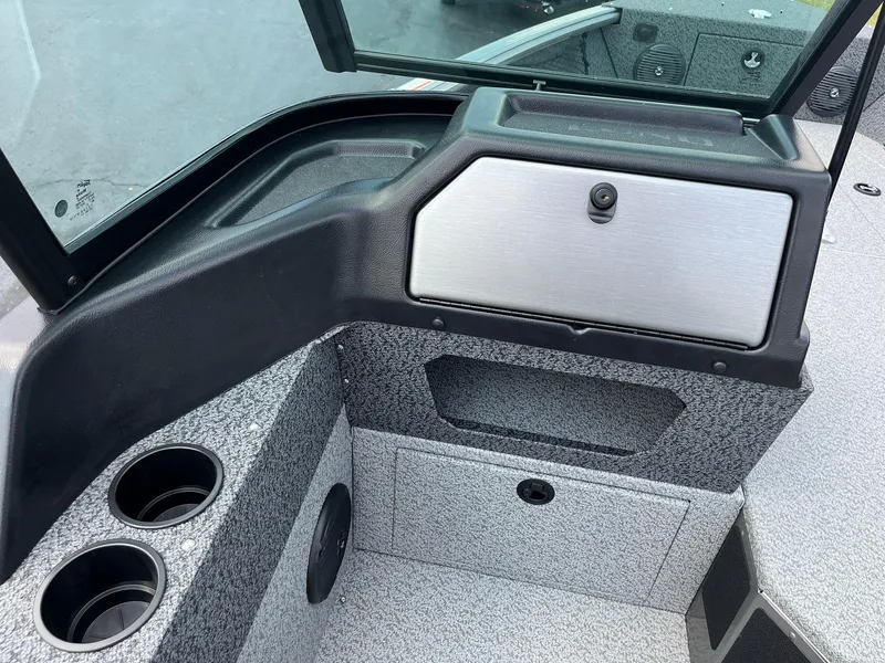 Slide: The Image of 2026 Lund 1875 Impact XS Sport boat dashboard with steering wheel and controls. - 18