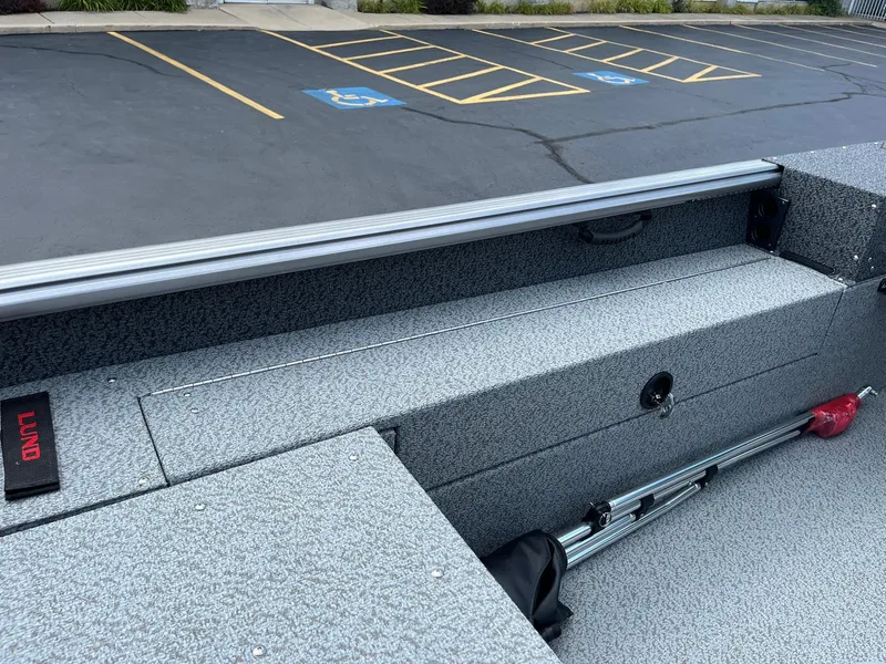 Slide: The Image of Control panel of 2026 Lund 1875 Impact XS Sport boat with various switches. - 19