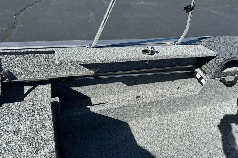 Slide: The Image of 2026 Lund 1875 Impact XS Sport boat interior with gray textured flooring. - 25