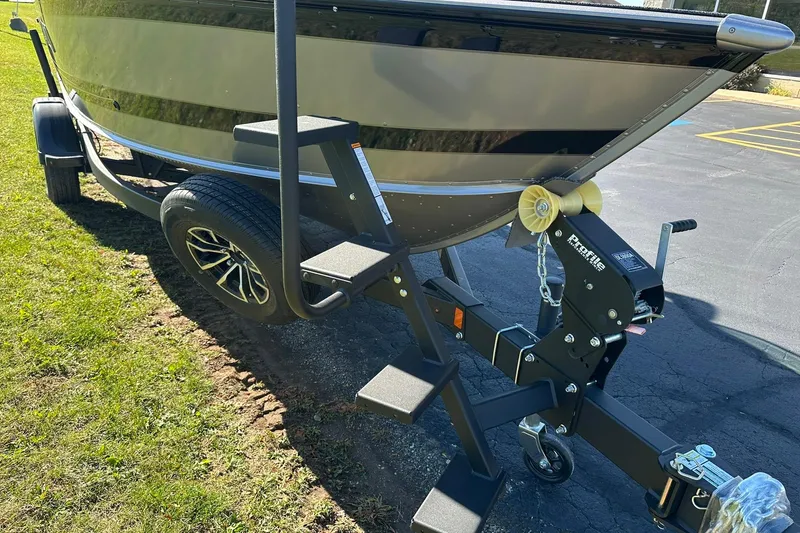 Slide: The Image of 2026 Lund 1875 Impact XS Sport boat on trailer with step ladder and winch. - 28