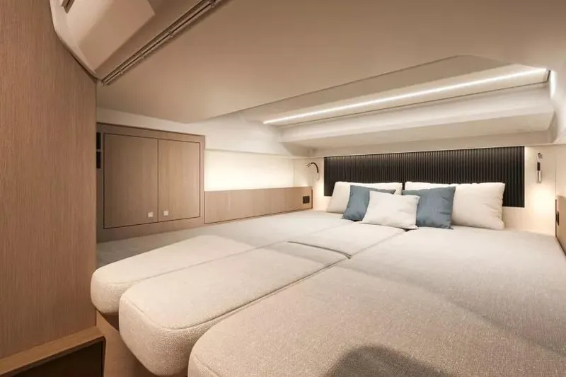 Slide: The Image of 2026 Beneteau Gran Turismo 35 yacht on clear blue water near rocky coastline. - 14