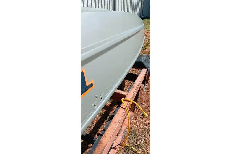 Slide: The Image of 2026 Tracker Topper 1236 boat on trailer, side view with yellow rope. - 14