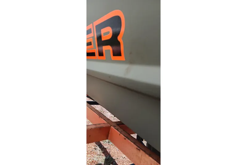 Slide: The Image of Close-up of 2026 Tracker Topper 1236 boat with orange lettering. - 3