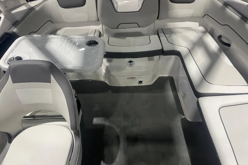 Slide: The Image of Interior of 2025 Yamaha Boats AR190, featuring seating and a table with cup holders. - 7
