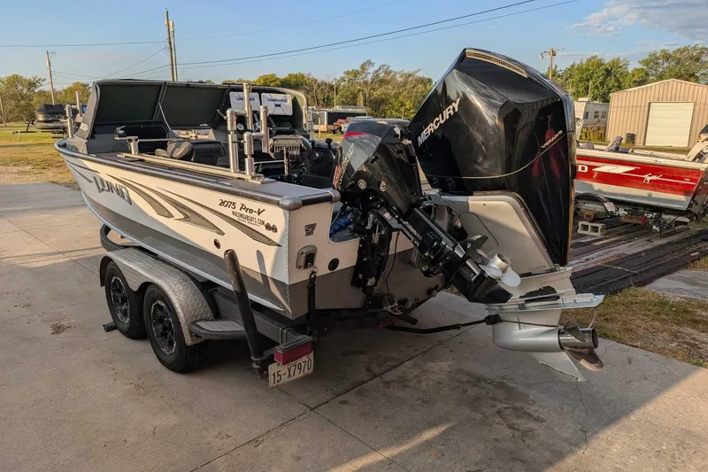 Slide: The Image of 2019 Lund 2075 Pro-V boat with Mercury outboard motor on a trailer. - 2