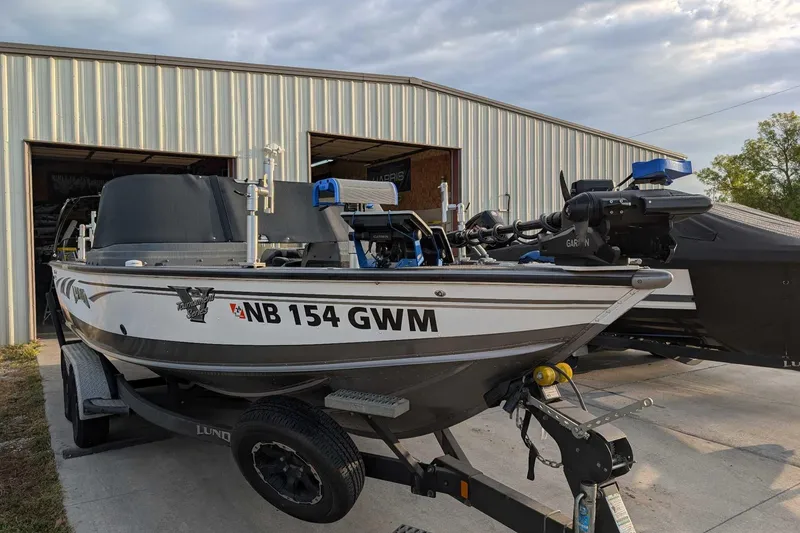 Slide: The Image of 2019 Lund 2075 Pro-V boat on trailer outside a metal building. - 3