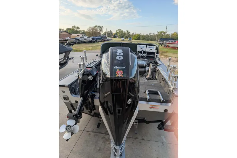 Slide: The Image of 2019 Lund 2075 Pro-V boat with powerful outboard motor, parked outdoors. - 5