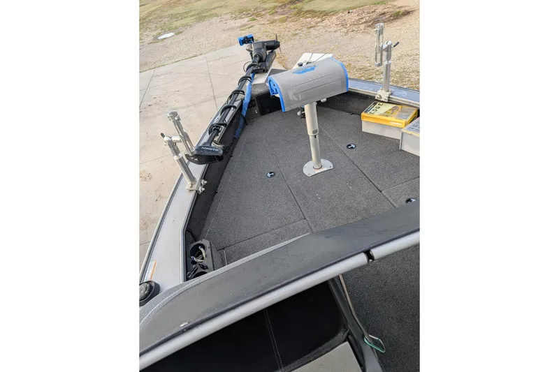 Slide: The Image of 2019 Lund 2075 Pro-V boat deck with fishing equipment and storage compartments. - 7