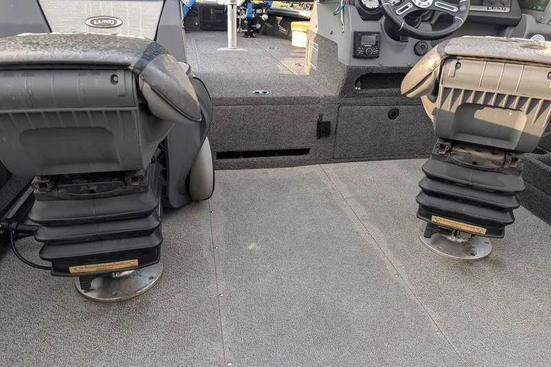 Slide: The Image of 2019 Lund 2075 Pro-V boat interior with adjustable seats and steering console. - 9