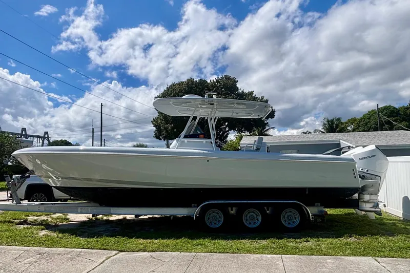 Slide: The Image of 2008 Intrepid 327 Center Console boat on trailer under blue sky. - 1
