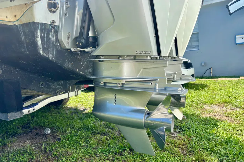 Slide: The Image of 2008 Intrepid 327 Center Console boat with dual outboard motors on grass. - 10