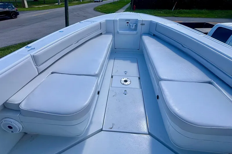 Slide: The Image of 2008 Intrepid 327 Center Console boat interior with white cushioned seating. - 11
