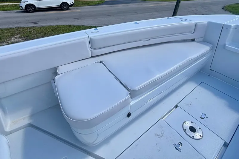 Slide: The Image of 2008 Intrepid 327 Center Console boat with white cushioned seating and deck. - 12