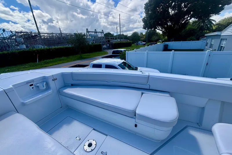 Slide: The Image of 2008 Intrepid 327 Center Console boat with white seating and storage compartments. - 13