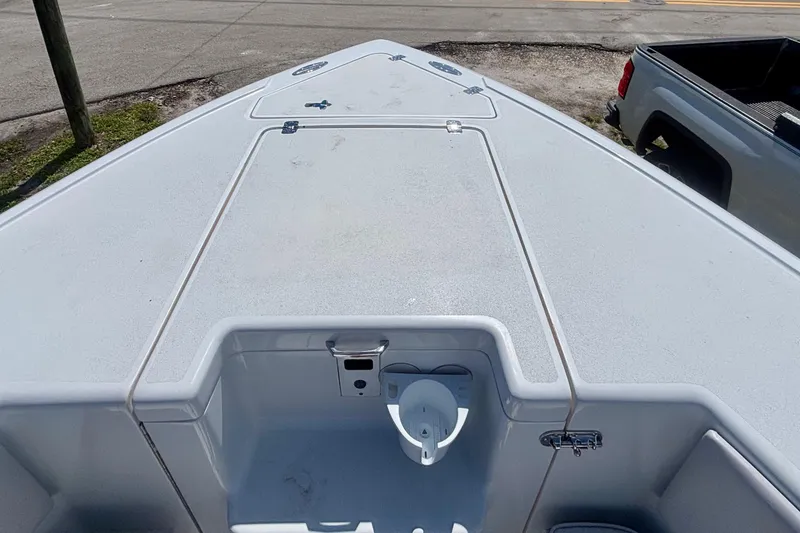 Slide: The Image of 2008 Intrepid 327 Center Console boat deck, featuring storage compartments and clean design. - 15