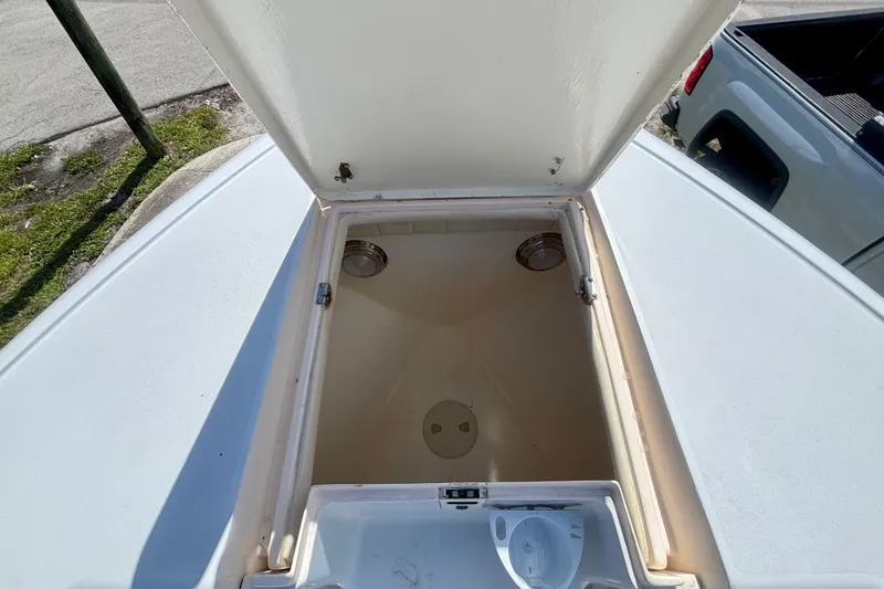 Slide: The Image of Open storage compartment on a 2008 Intrepid 327 Center Console boat. - 17