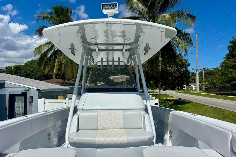 Slide: The Image of 2008 Intrepid 327 Center Console boat with seating, under a clear blue sky. - 19