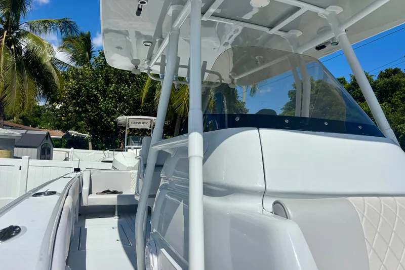 Slide: The Image of 2008 Intrepid 327 Center Console boat with sleek design, set against a tropical backdrop. - 20