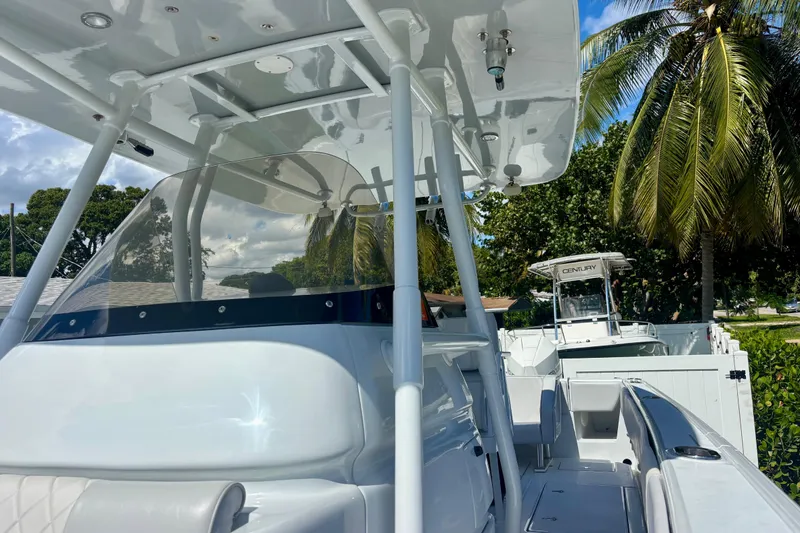 Slide: The Image of 2008 Intrepid 327 Center Console boat with sleek design, palm trees in background. - 22