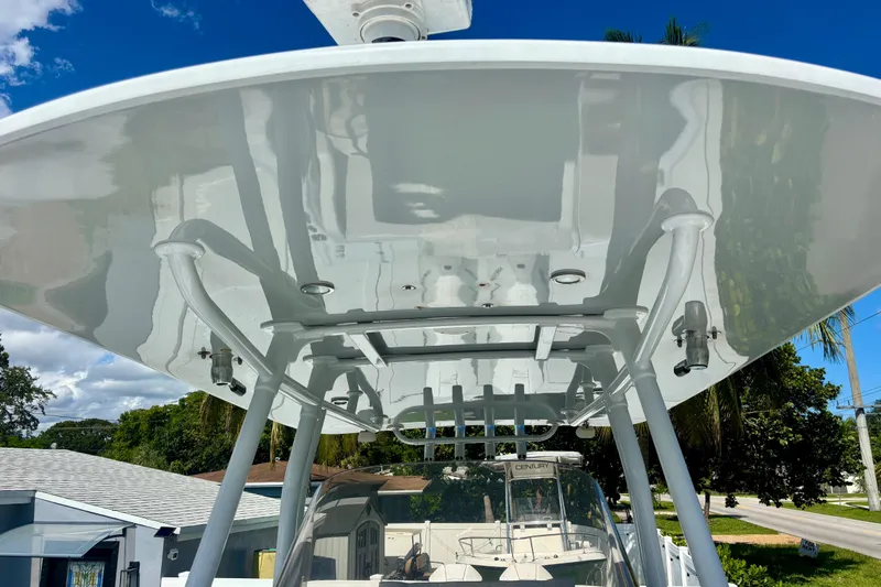 Slide: The Image of 2008 Intrepid 327 Center Console boat with sleek T-top design under clear blue sky. - 23