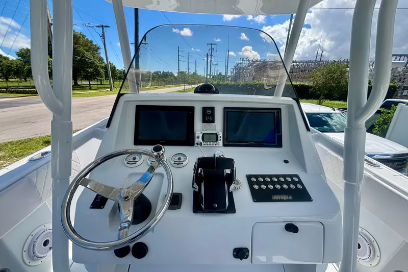 Slide: The Image of 2008 Intrepid 327 Center Console helm with steering wheel and navigation screens. - 26