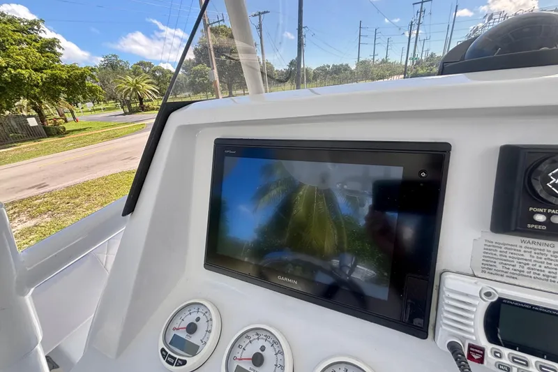 Slide: The Image of 2008 Intrepid 327 Center Console dashboard with Garmin display and gauges. - 27