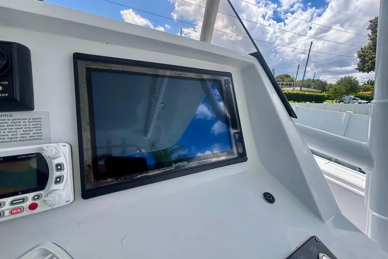 Slide: The Image of 2008 Intrepid 327 Center Console dashboard with Garmin GPS and Explorer VHF radio. - 28