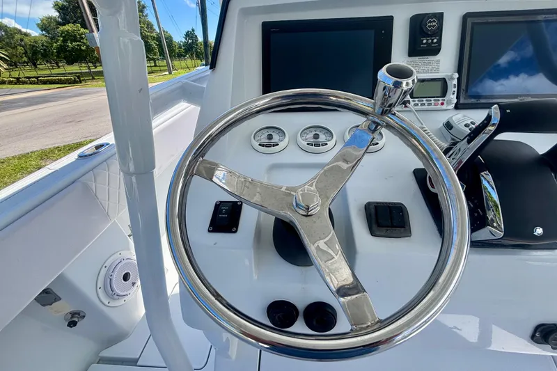 Slide: The Image of 2008 Intrepid 327 Center Console helm with steering wheel and navigation controls. - 31