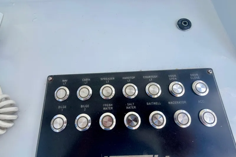 Slide: The Image of Control panel of a 2008 Intrepid 327 Center Console boat with labeled buttons. - 32
