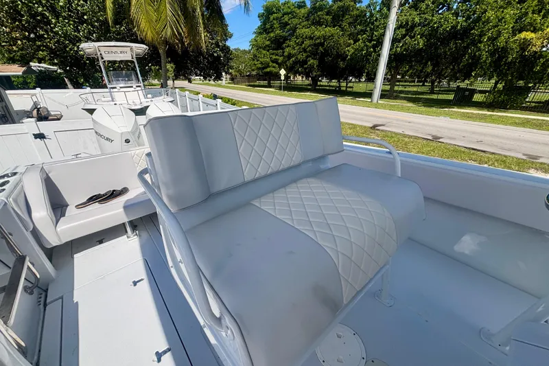Slide: The Image of 2008 Intrepid 327 Center Console boat with cushioned seating and outdoor view. - 33