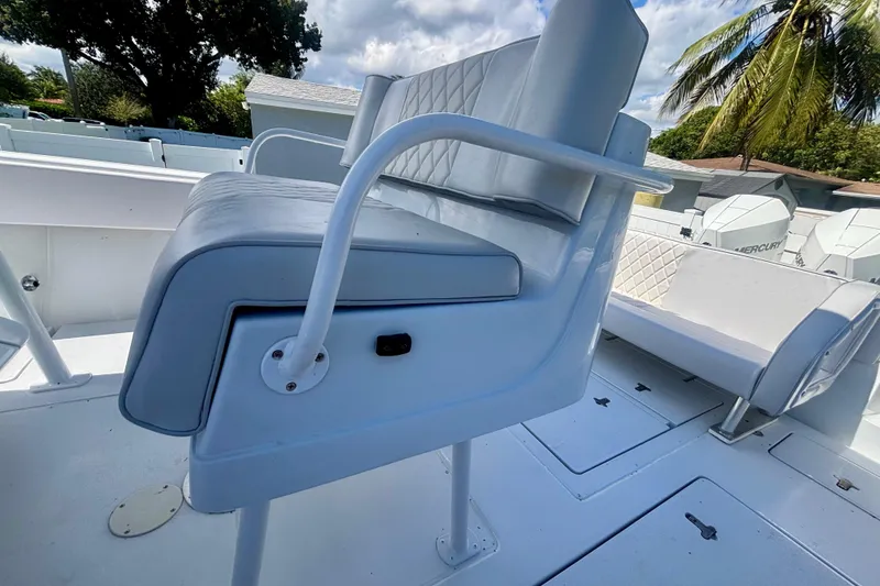 Slide: The Image of 2008 Intrepid 327 Center Console boat interior with cushioned seating and storage compartments. - 34