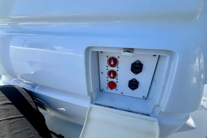 Slide: The Image of Control panel on a 2008 Intrepid 327 Center Console boat, featuring switches and dials. - 35