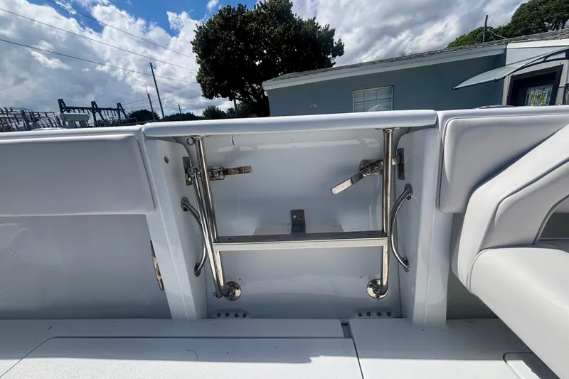 Slide: The Image of 2008 Intrepid 327 Center Console boat ladder and seating detail under a cloudy sky. - 39