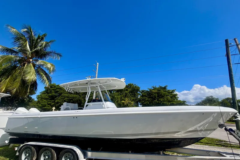 Slide: The Image of 2008 Intrepid 327 Center Console boat on trailer under clear blue sky. - 5
