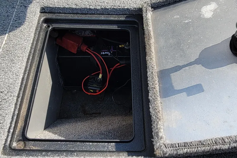 Slide: The Image of Battery compartment of a 2016 Tracker boat with visible wiring and connections. - 16