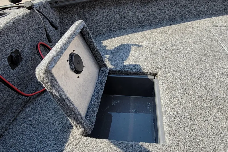Slide: The Image of 2016 Tracker boat storage compartment with open lid and visible wiring. - 20
