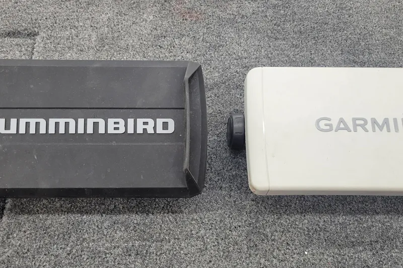 Slide: The Image of Two electronic devices, Humminbird and Garmin, on a gray carpeted surface. - 22