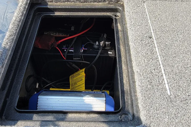 Slide: The Image of Battery compartment of a 2016 Tracker boat with visible wiring and components. - 29