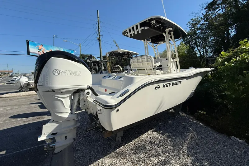 Slide: The Image of 2024 Key West 244 Center Console boat with Yamaha engine, parked outdoors. - 3