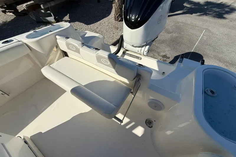Slide: The Image of 2024 Key West 244 Center Console boat interior with seating and motor. - 8